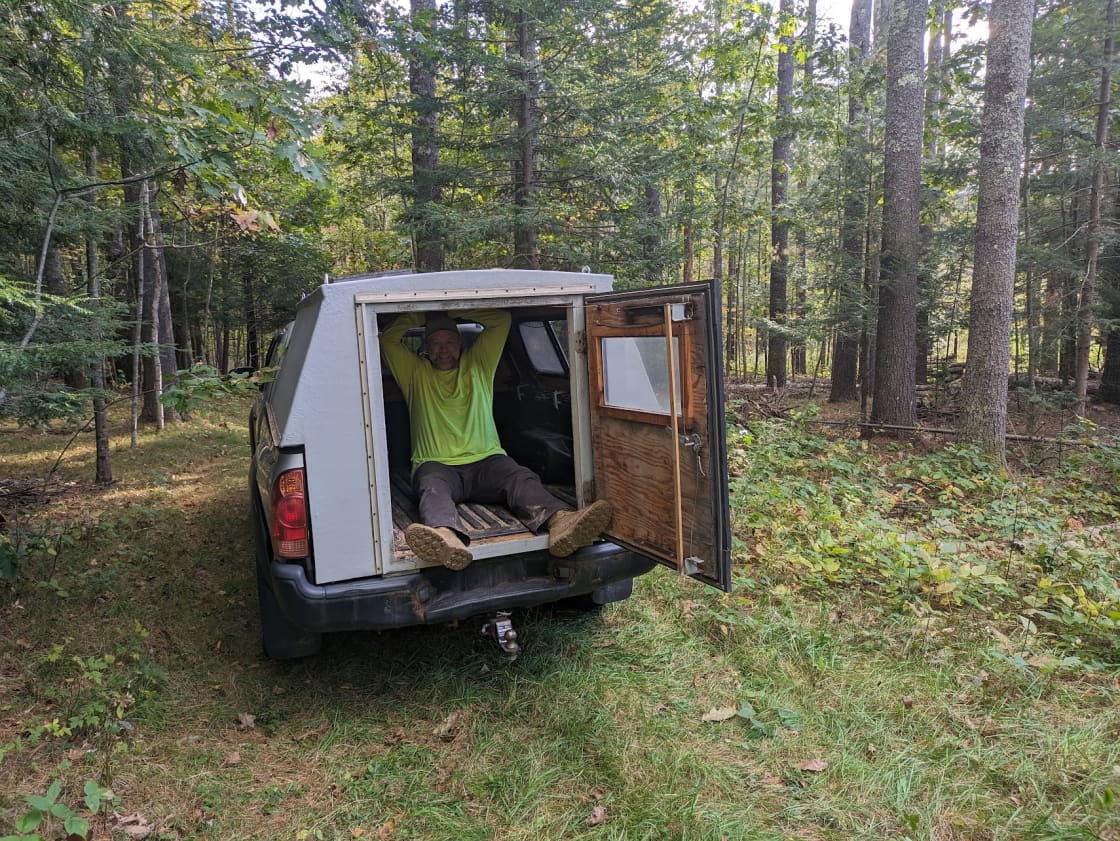 Andrew in our old truck. Parking is flexible! - feel free to park in any portions of the woods roads above the first woodshed on the right. 