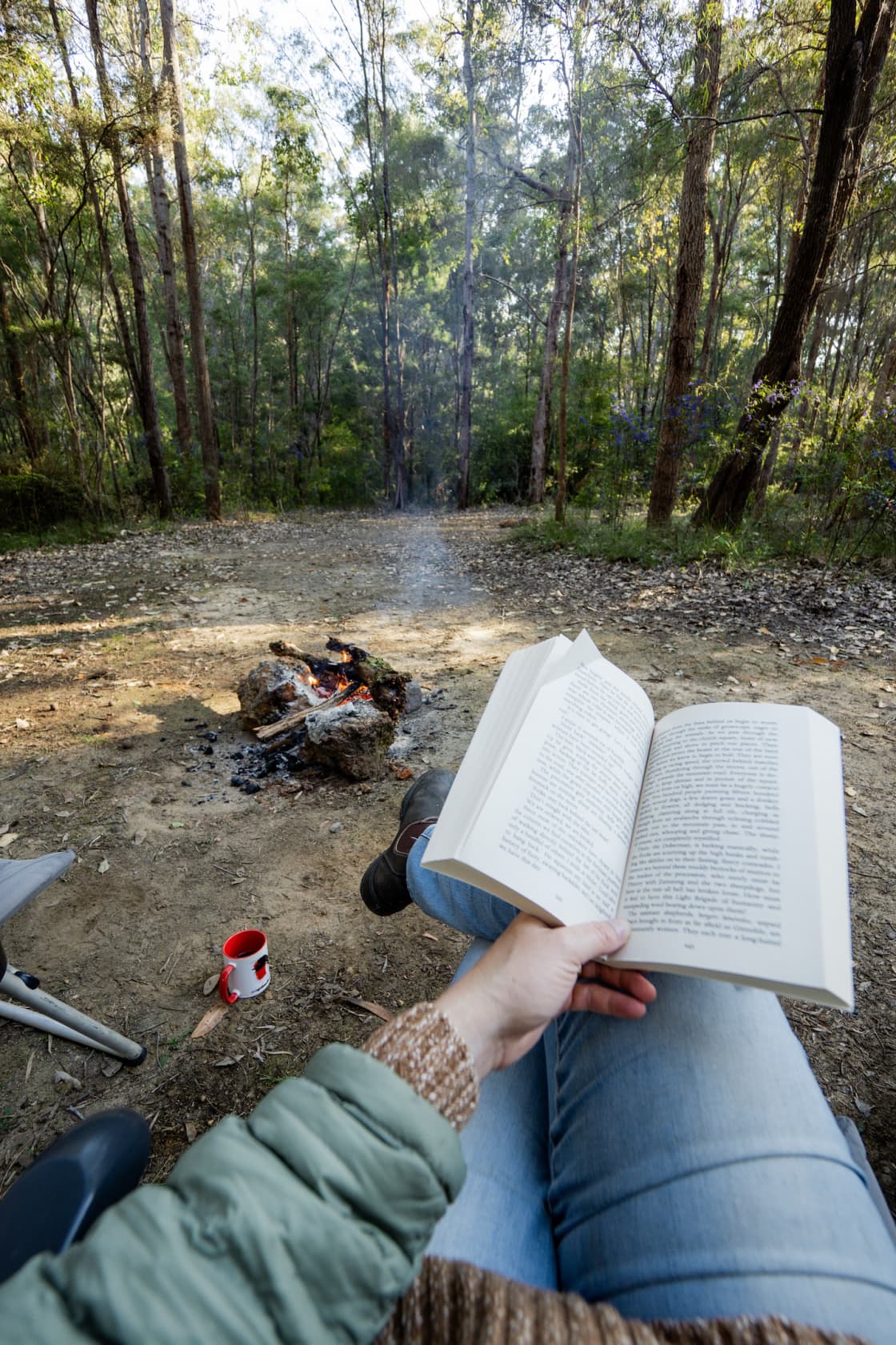 Reading by the campfire in the morning