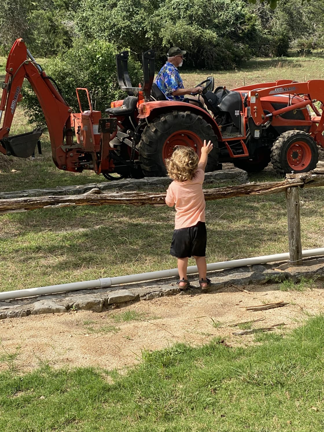 Grandson directing Poppop on tractor operation at Homestead Farm