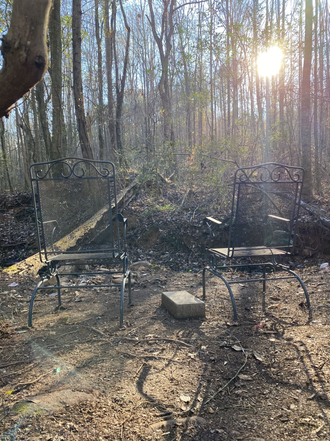 Two metal
Chairs overlooking creek. 