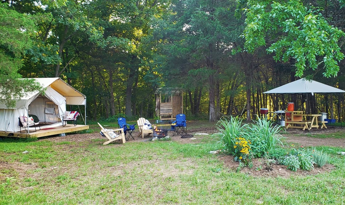 Our sites have a platform tent, campfire area, kitchen tent, and private shower/loo.