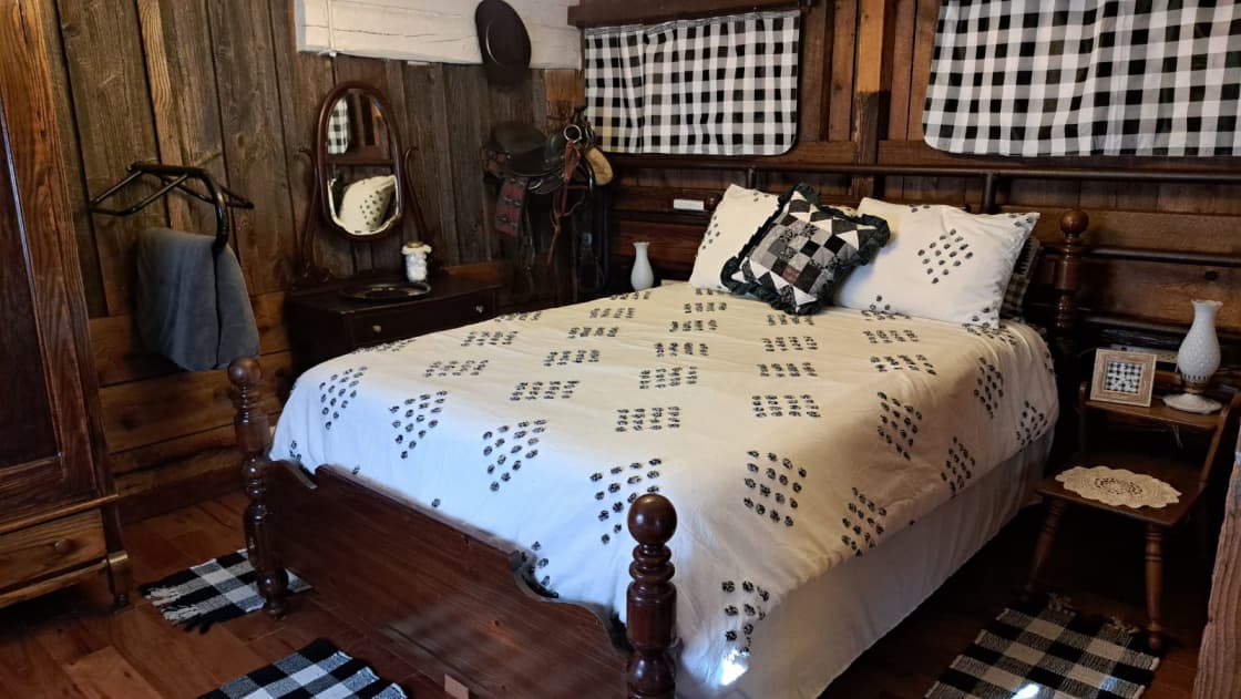The largest stall is the bedroom with a queen bed, restored 1800's armoire, and an equestrian theme.