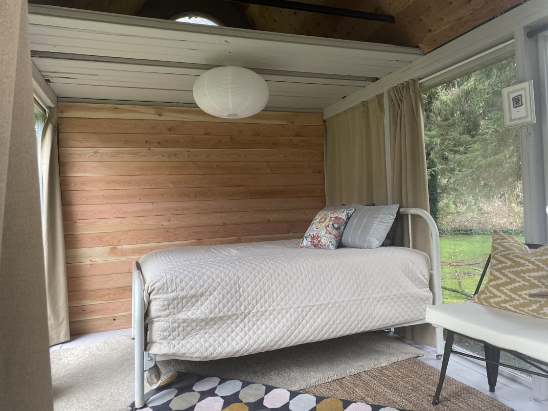 Our Bunkie, the Glass House. It sleeps two comfortably with beautiful views all around. Black out curtains cover the windows for privacy at night.