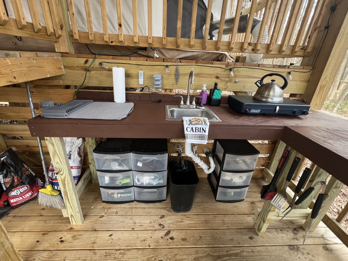 The kitchenette offers a propane stove, camp cookware, and many other needed utensils and equipment.