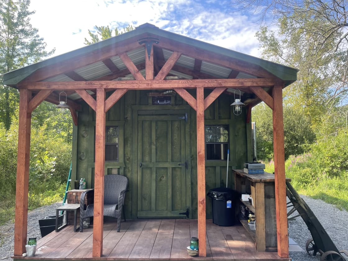 Front of private camp. Has porch and chairs to chill and bar to make dinner or drinks. Cabin has four windows for nice cross breeze. Cabin on 4 acres.