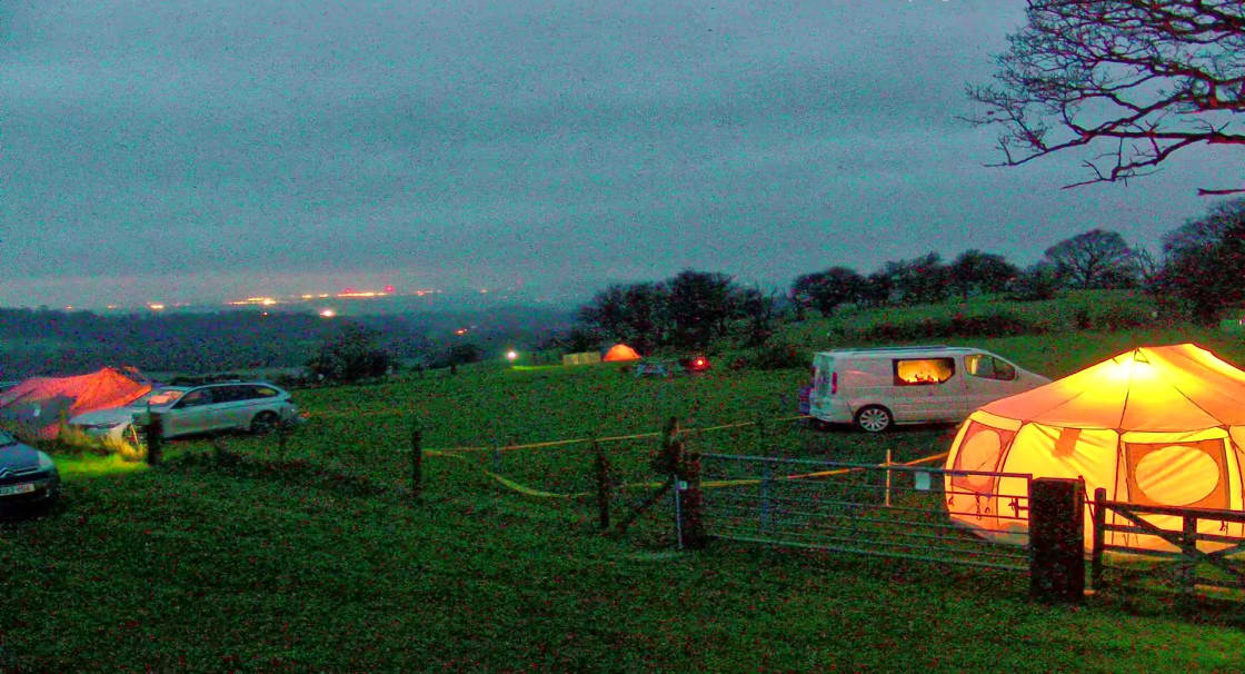 Campsite at dusk with distant lights of Shrewsbury