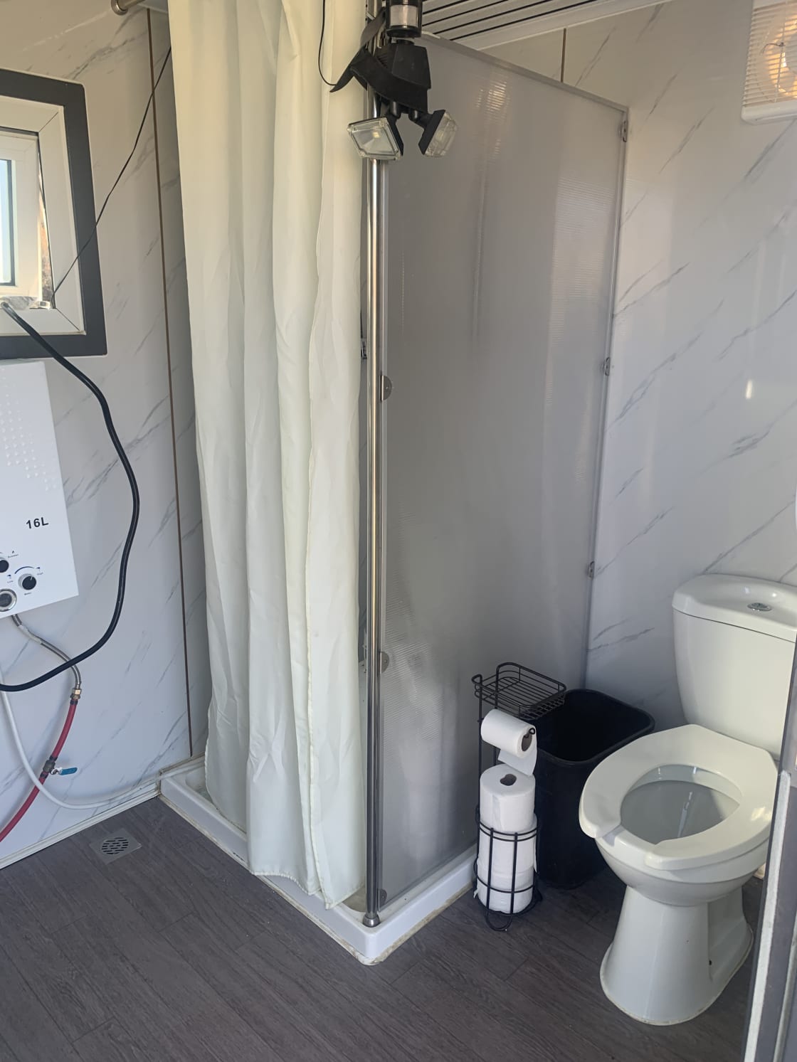 Flushing toilet and instant hot water shower stall