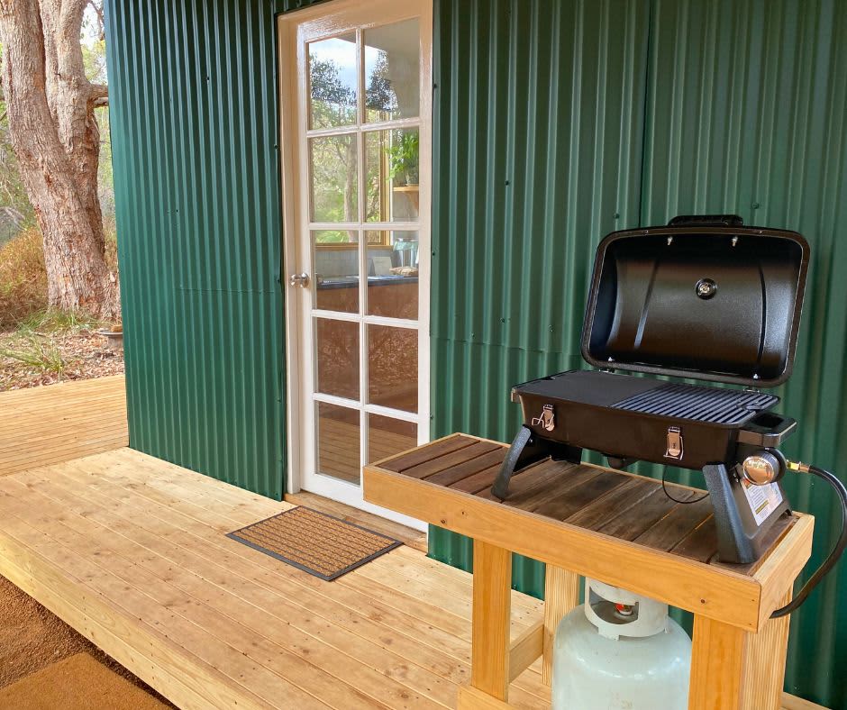 Private outdoor deck with portable gas bbq for cooking.