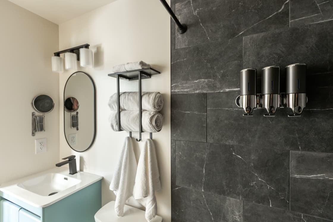  Our Bathroom: Discover a Stylish Oval Mirror, Soft Towels, and Convenient Dispensers for Shampoo, Conditioner, and Bath Soap, Exclusively at BlueWater.