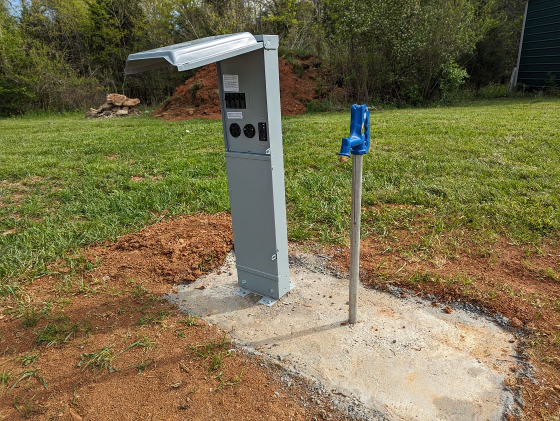 Spigot for county water; Electric pedestal for 50, 30, and 20 amp service. Caution: Water pressure is high.