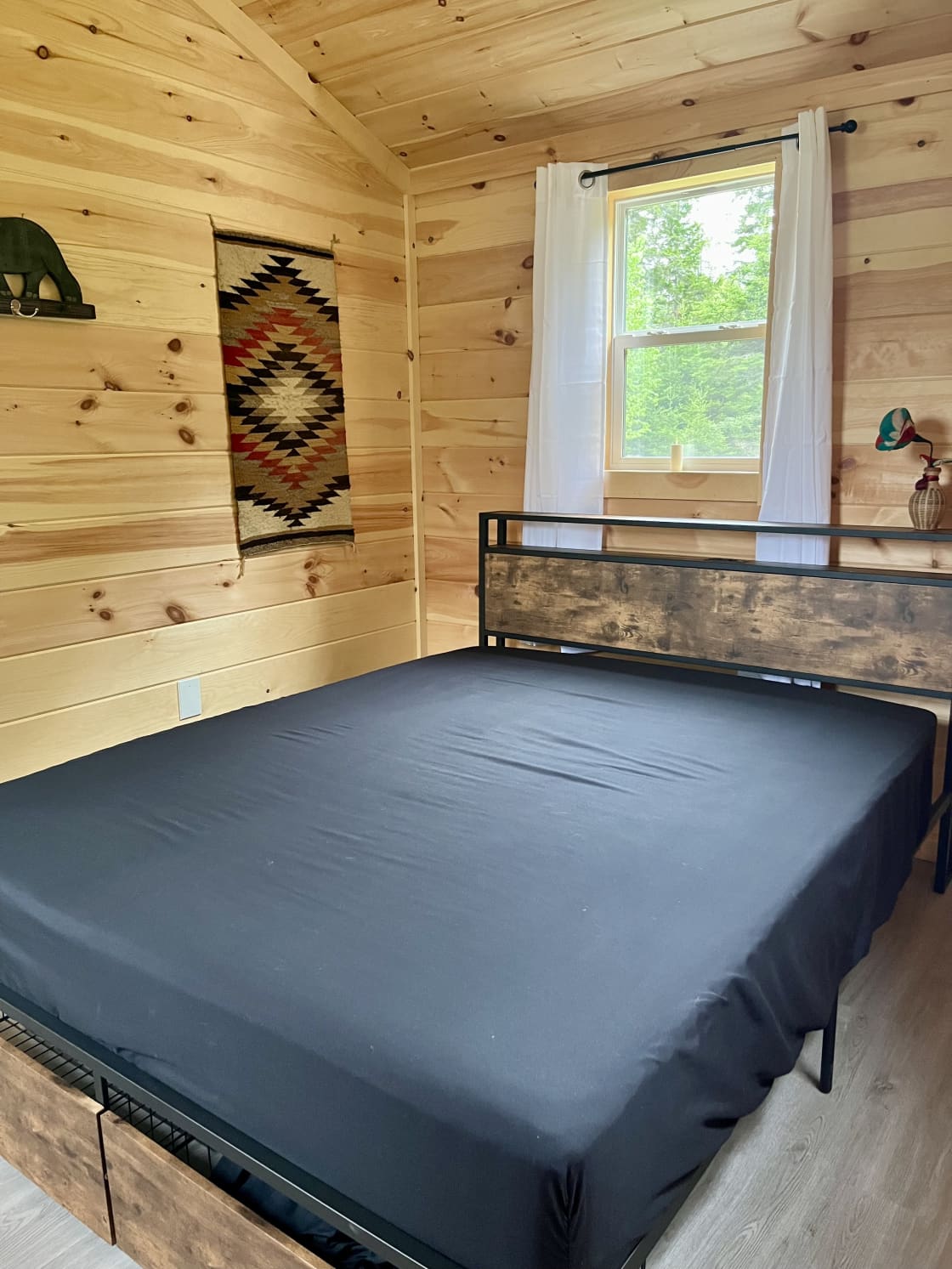 Bedroom with queen-sized bed, fitted sheet over mattress pad, and super comfy mattress.