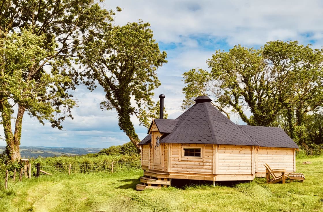 Two cabins nestled into the corner of one of our quiet fields, with views over Exmoor stretching 30 miles