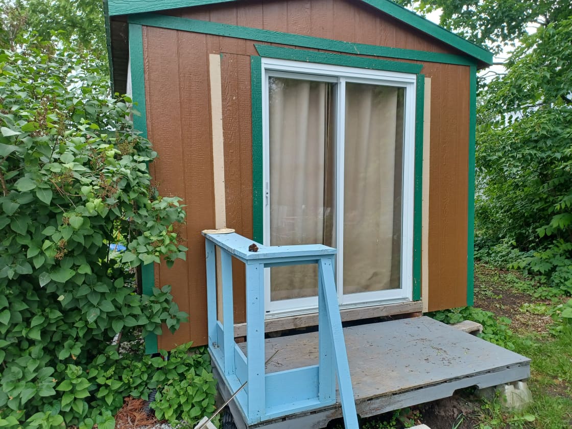 This is the porch for the Eco Glamping Cabin (EGC). The steps are 6 inches high. The curtain blocks the sun, which would heat up the EGC.