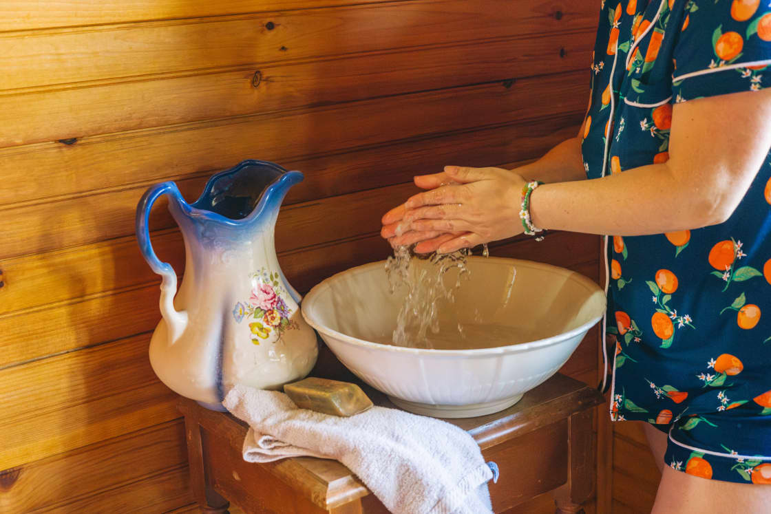Michele provides a pitcher, bowl, and water for hand and face washing. 