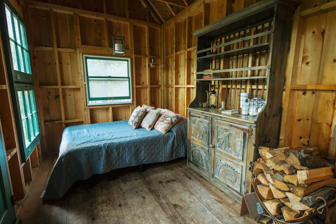 Inside you'll find a wood burning oven, comfy bed, and candles. 