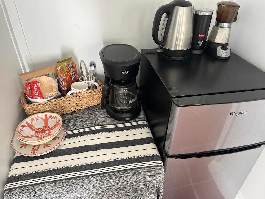 Small kitchenette includes coffee maker, electric mocha pot, frother, hot water kettle, cutlery and dishes for 2 people. 