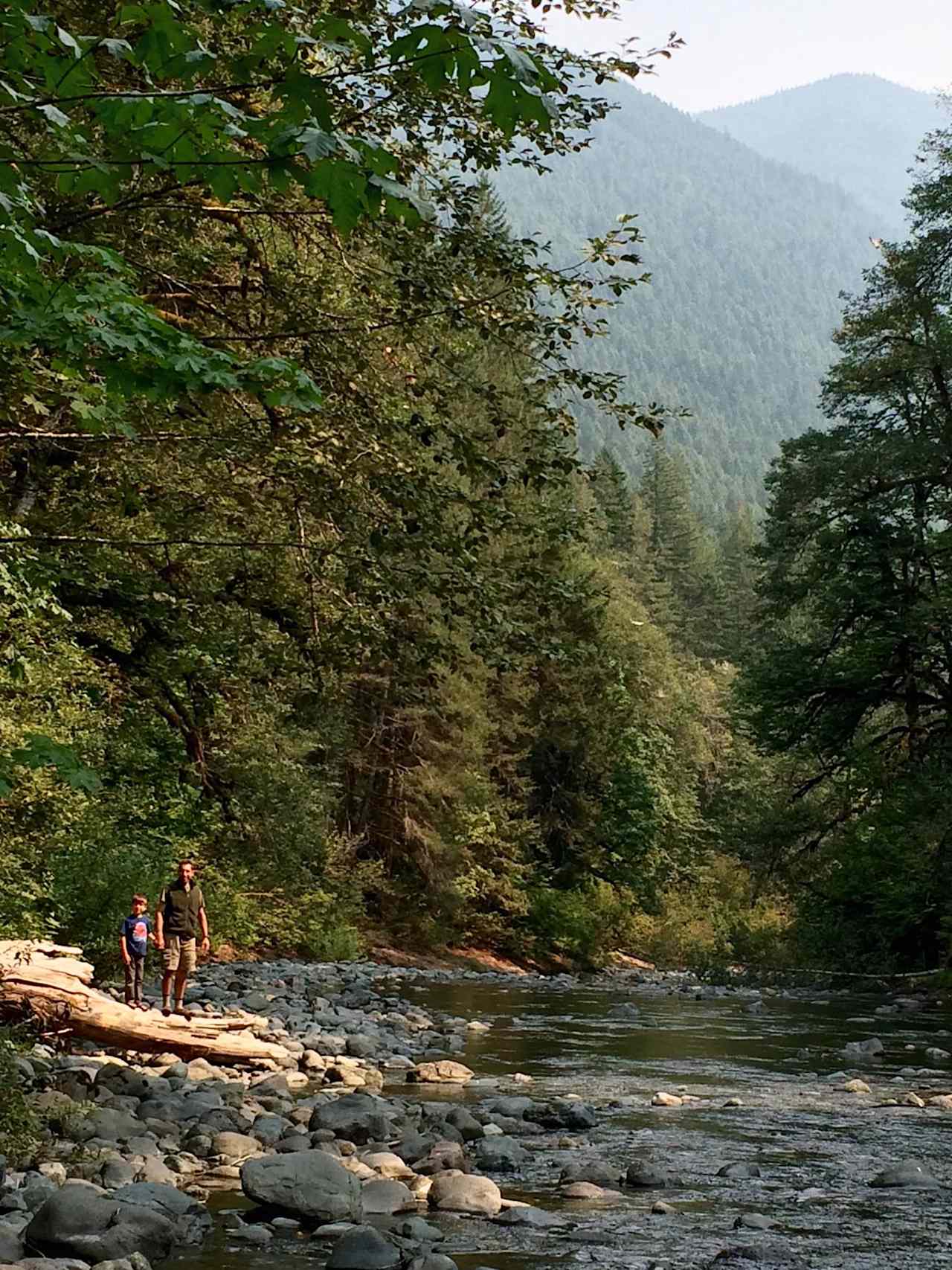 My husband and son, standing beside the river.