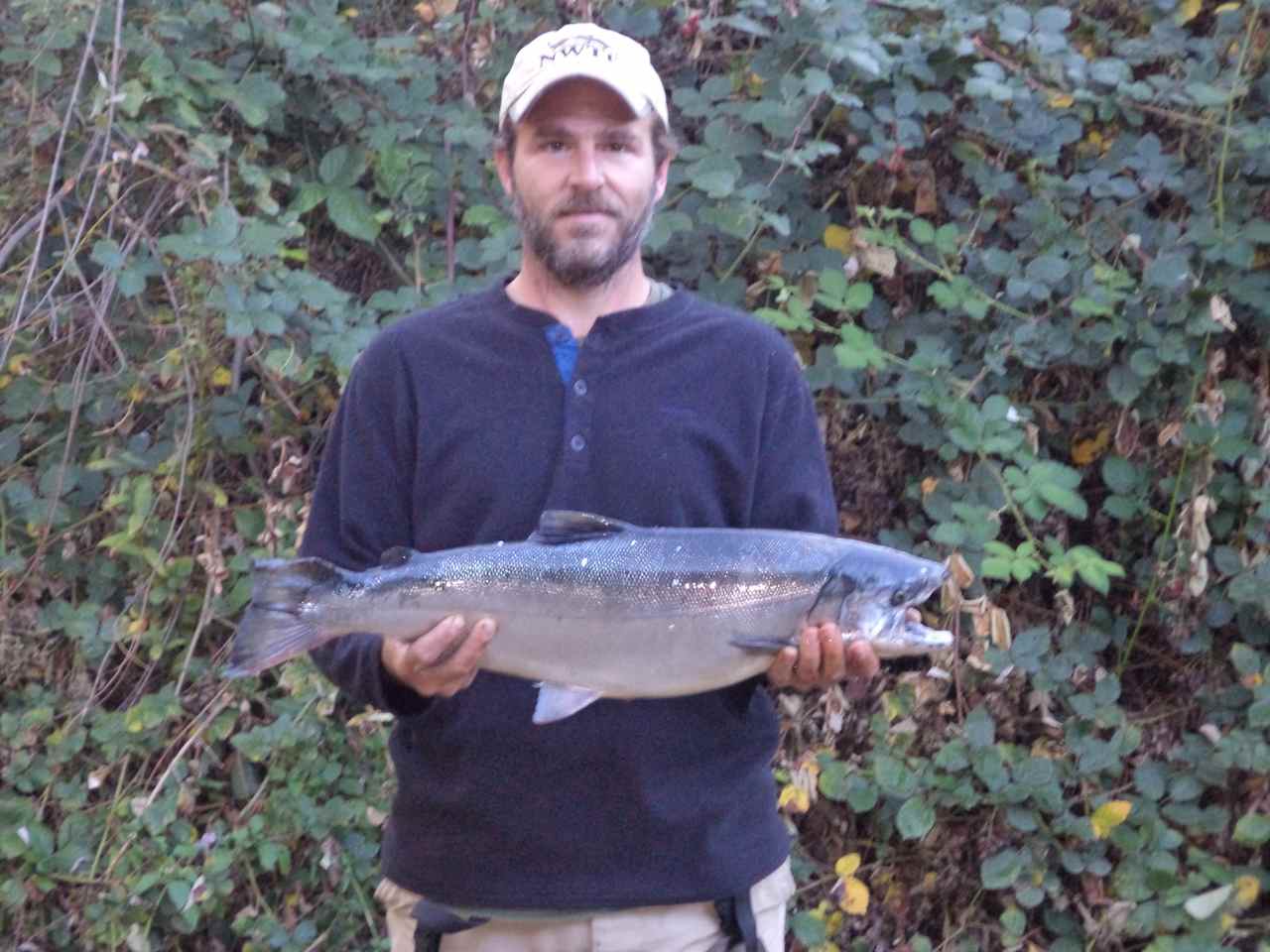 Our caretaker and sustainable living master Joe Moore with a salmon he just caught in the river below the Yurt.