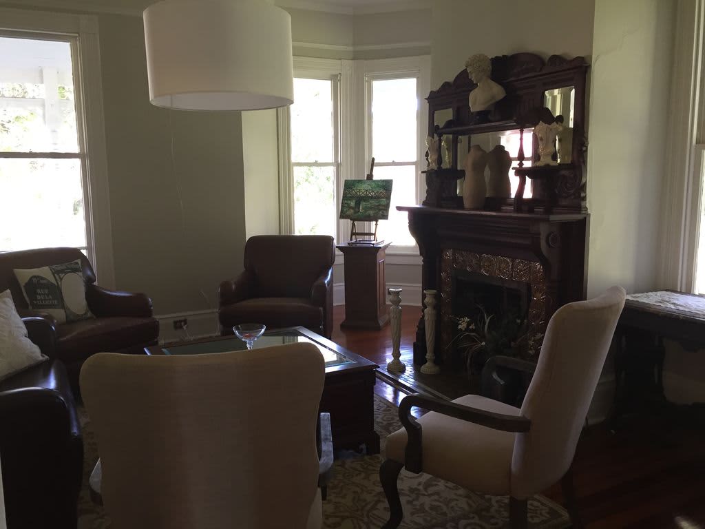 Living room with leather chairs and loveseat by the fireplace