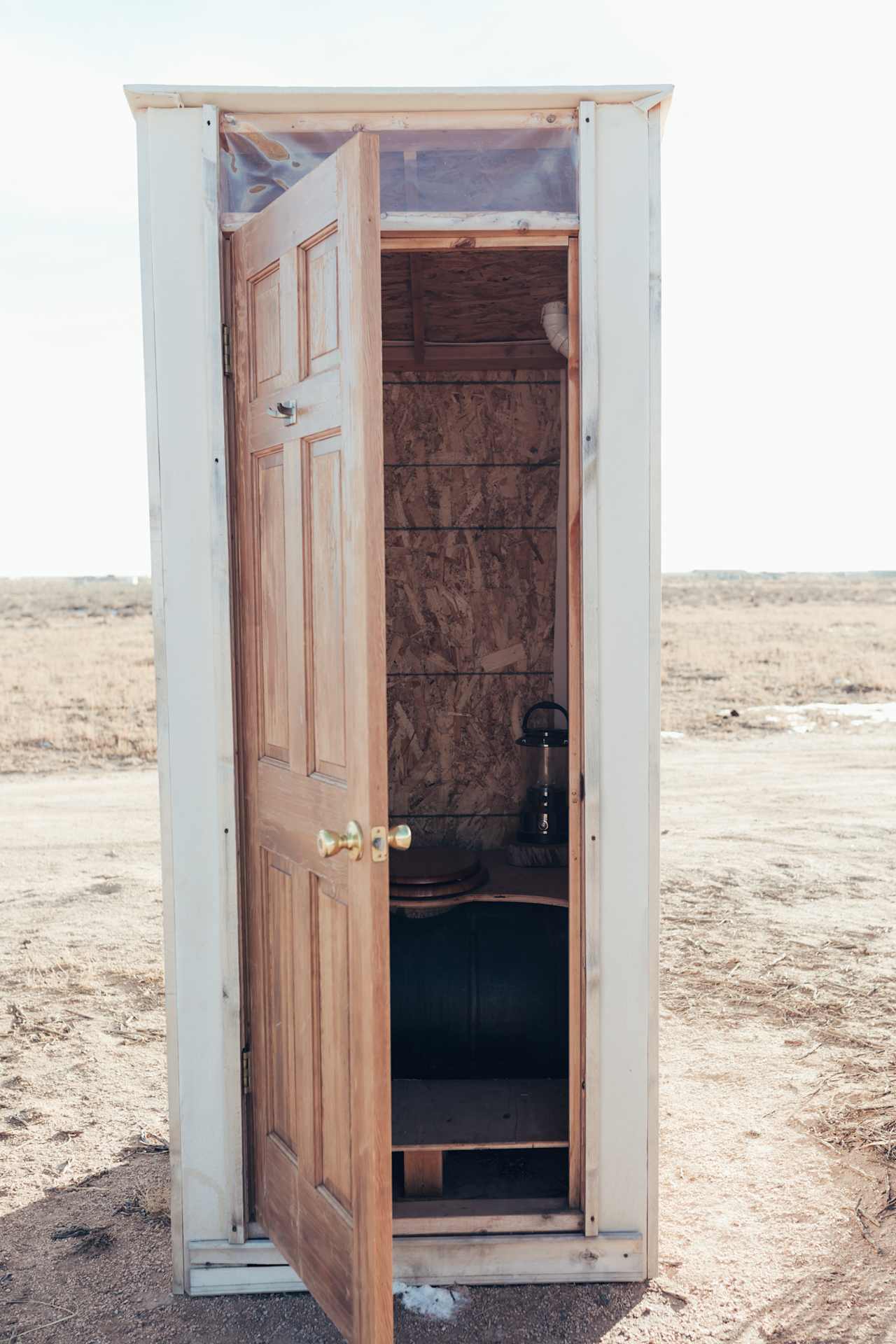 The cute little outhouse has a composting toilet and lantern for night-time use. 