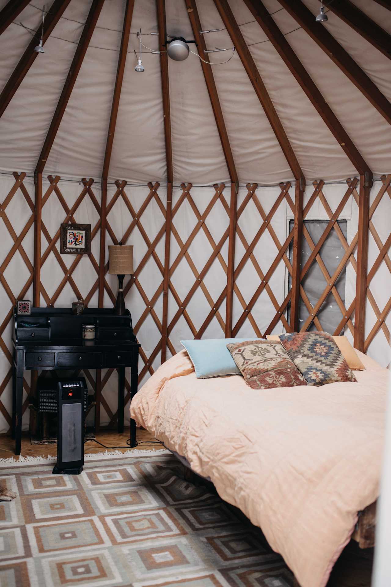 Nice queen bed next to a desk and chair