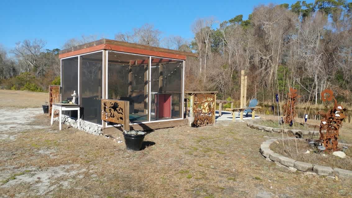 Our favorite spot is our outdoor living room overlooking the half acre pond. It is completely screened in even the roof so you can see the stars.