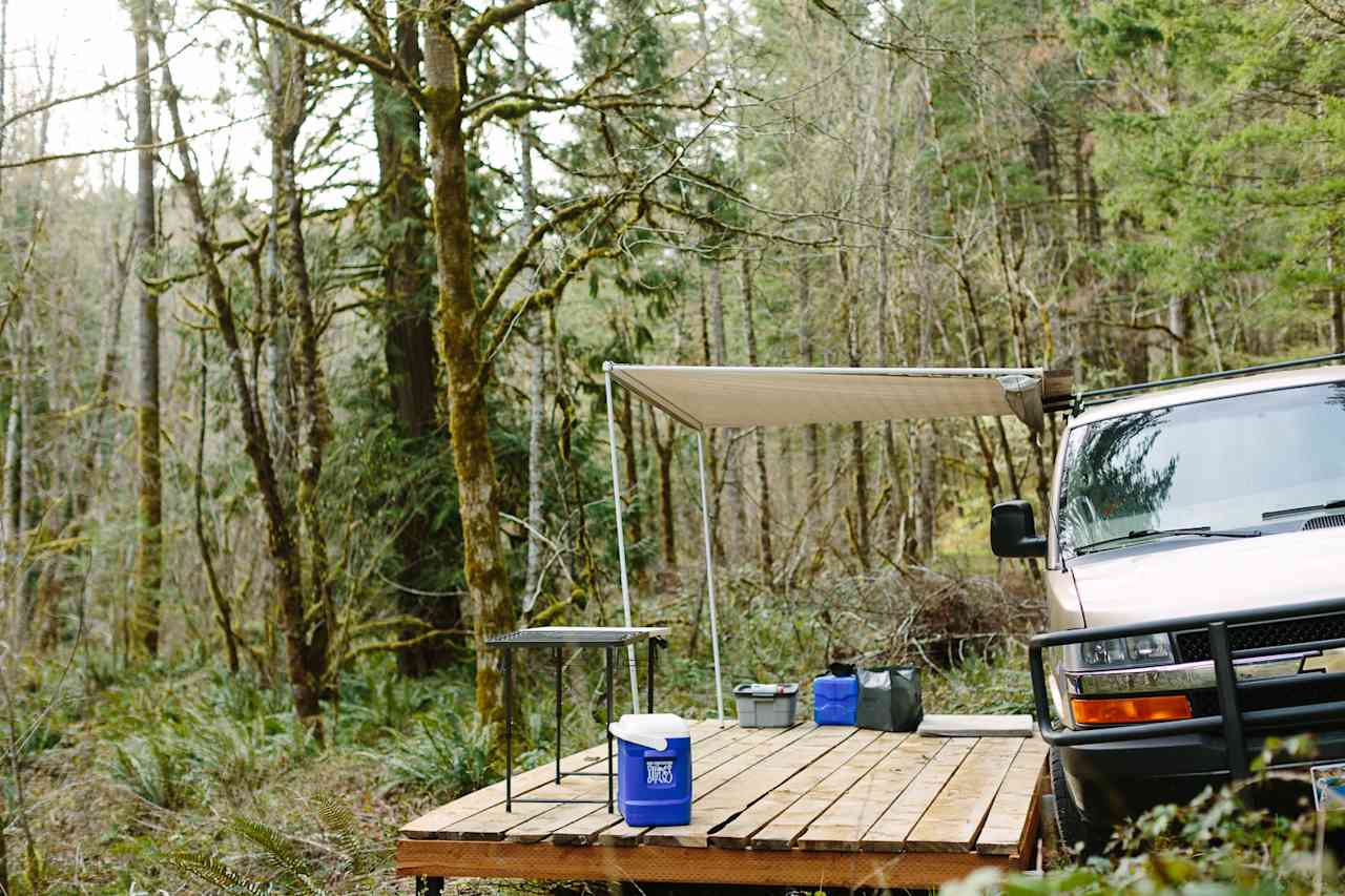 Or, park your van next to the deck overlooking the tent spot. Pro-tip: bring an awning to put over the deck for shade or a rain shelter.