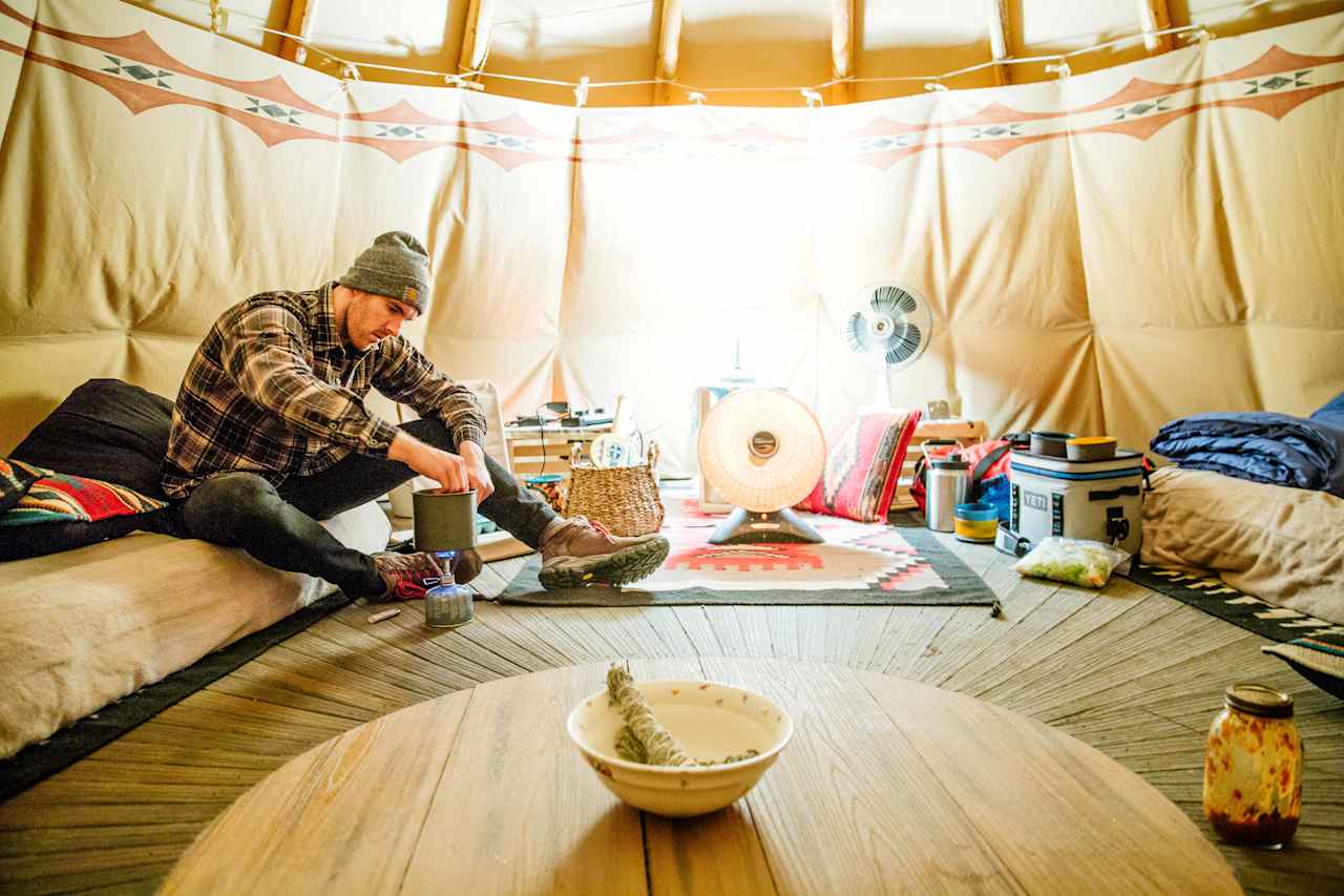 Dan working on dinner inside the Tipi! :) 