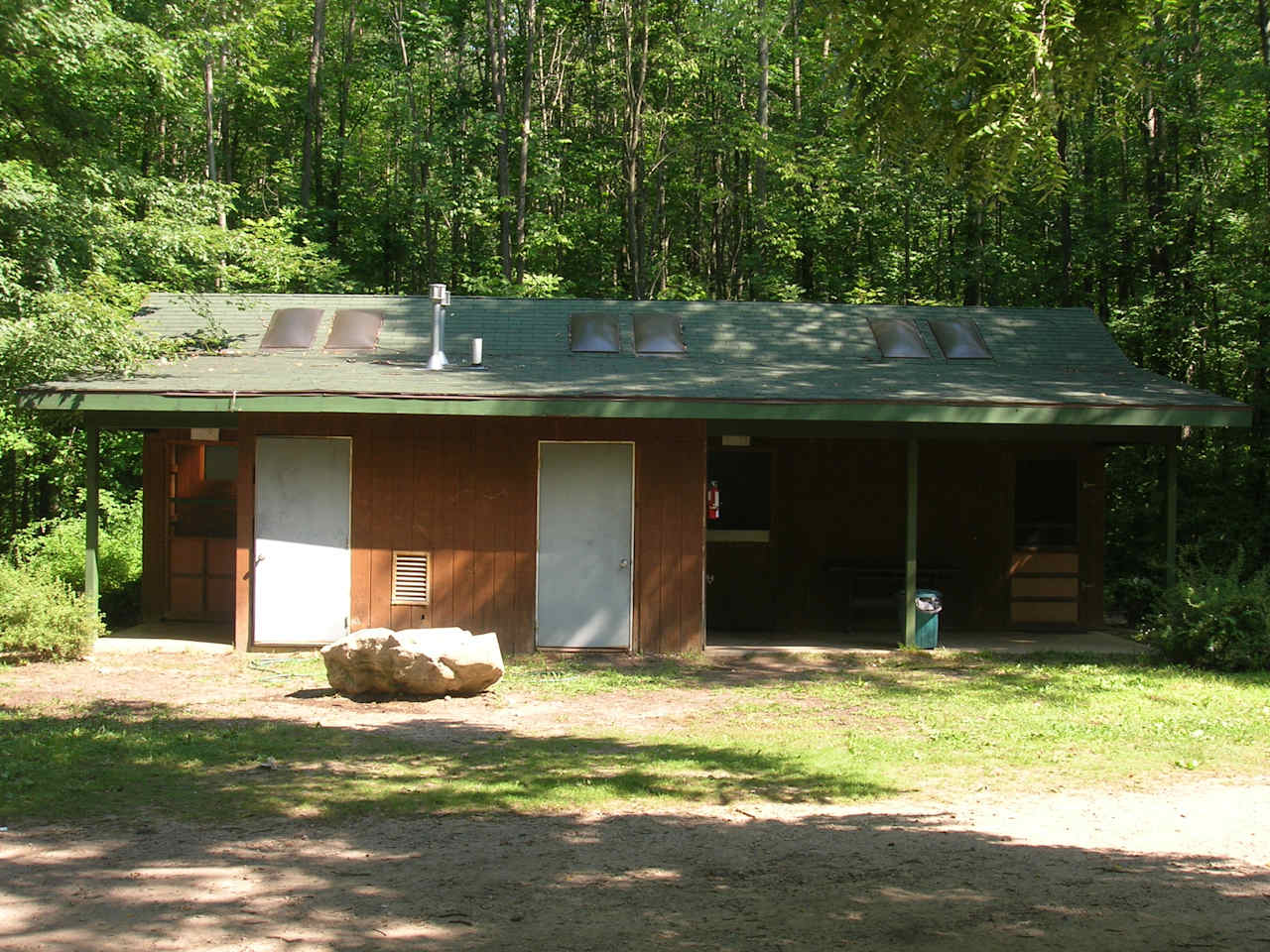 Shower House divided into 3 sections. Each section has two toilets, two sinks and two showers with hot and cold water. 