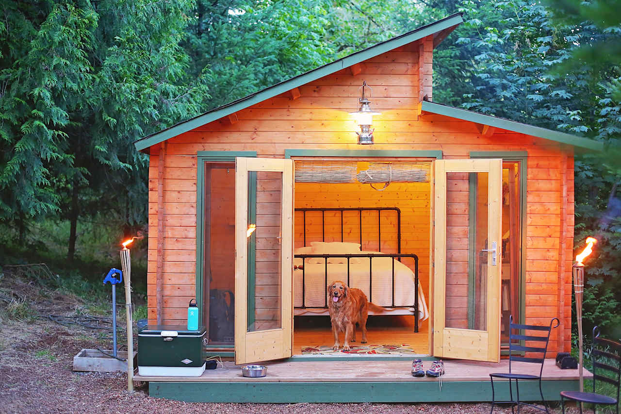 Tiki torches light the outside and fairy lights light the inside of the cabin.