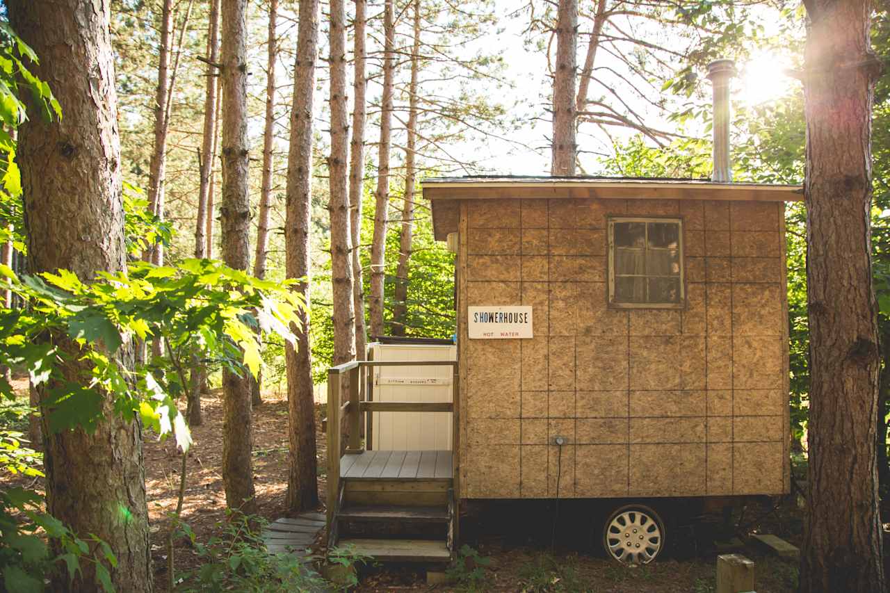 Camp Moonshadow has showers! Show inside the showerhouse, or out! 