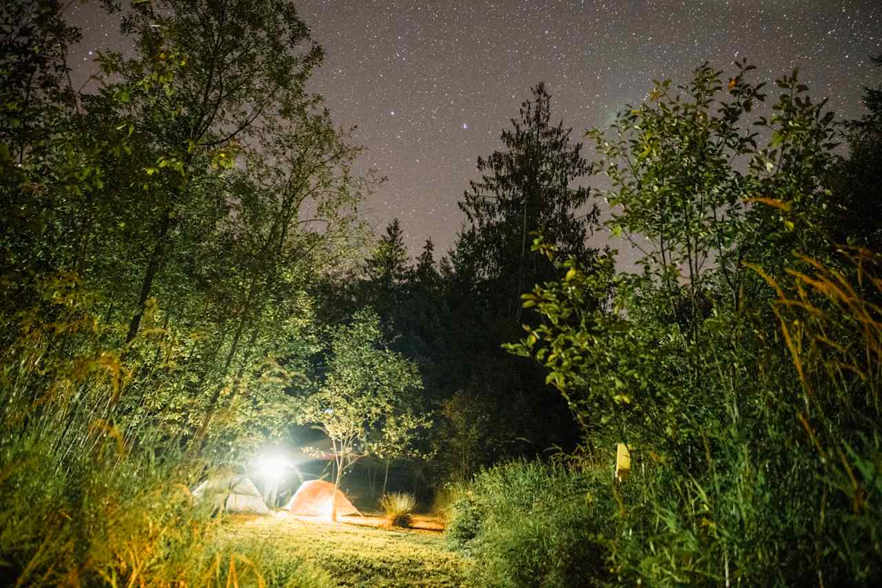 A few stars over a tent area.