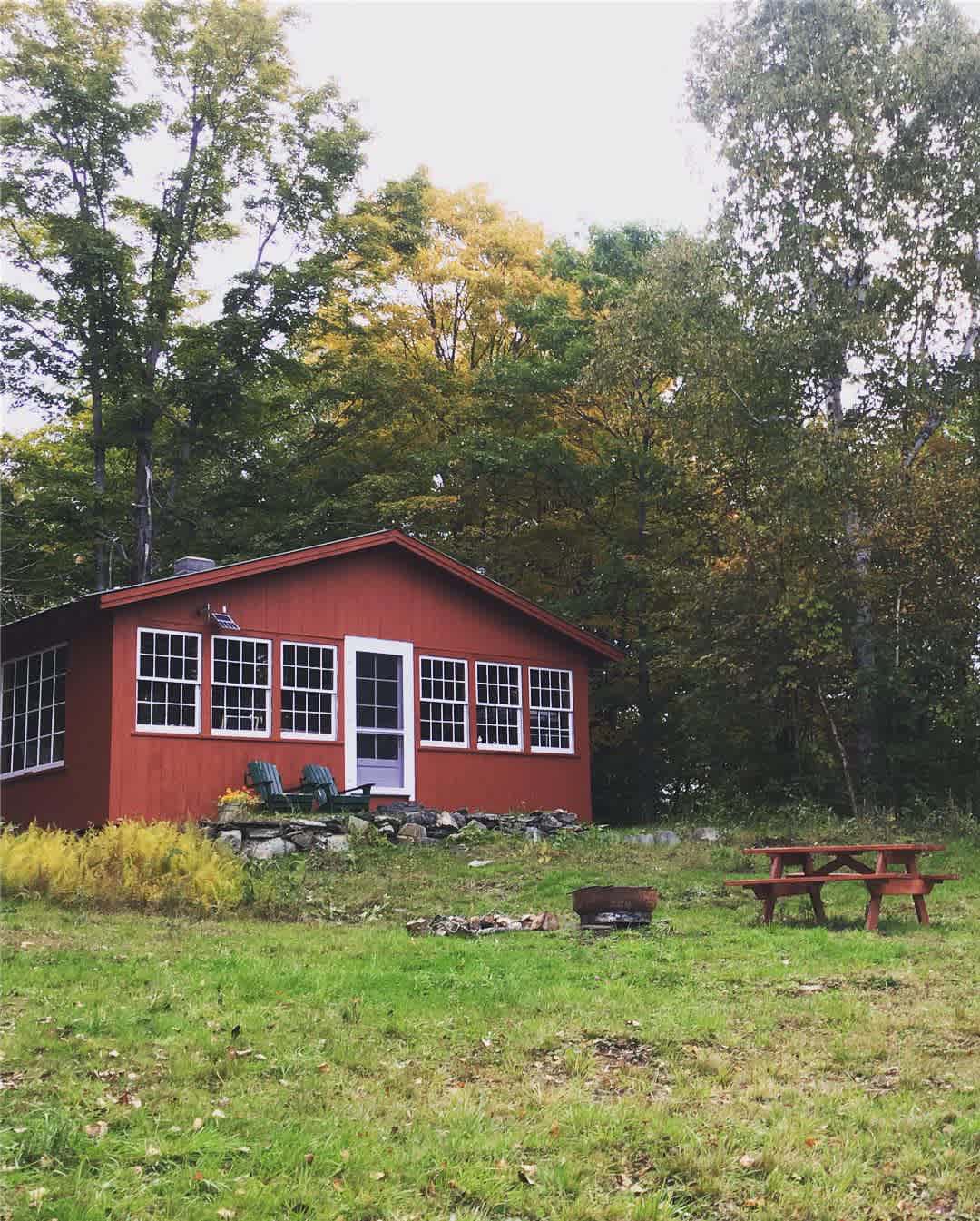 Fire pit and picnic table outside. Outhouse to the right of the cabin, downhill. 