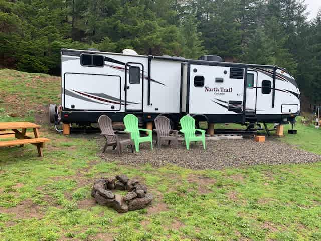 36 feet of Glamping! The North Umpqua Trail Camper is fully stocked and situated along the tree line with a spectacular view of the Umpqua valley. 