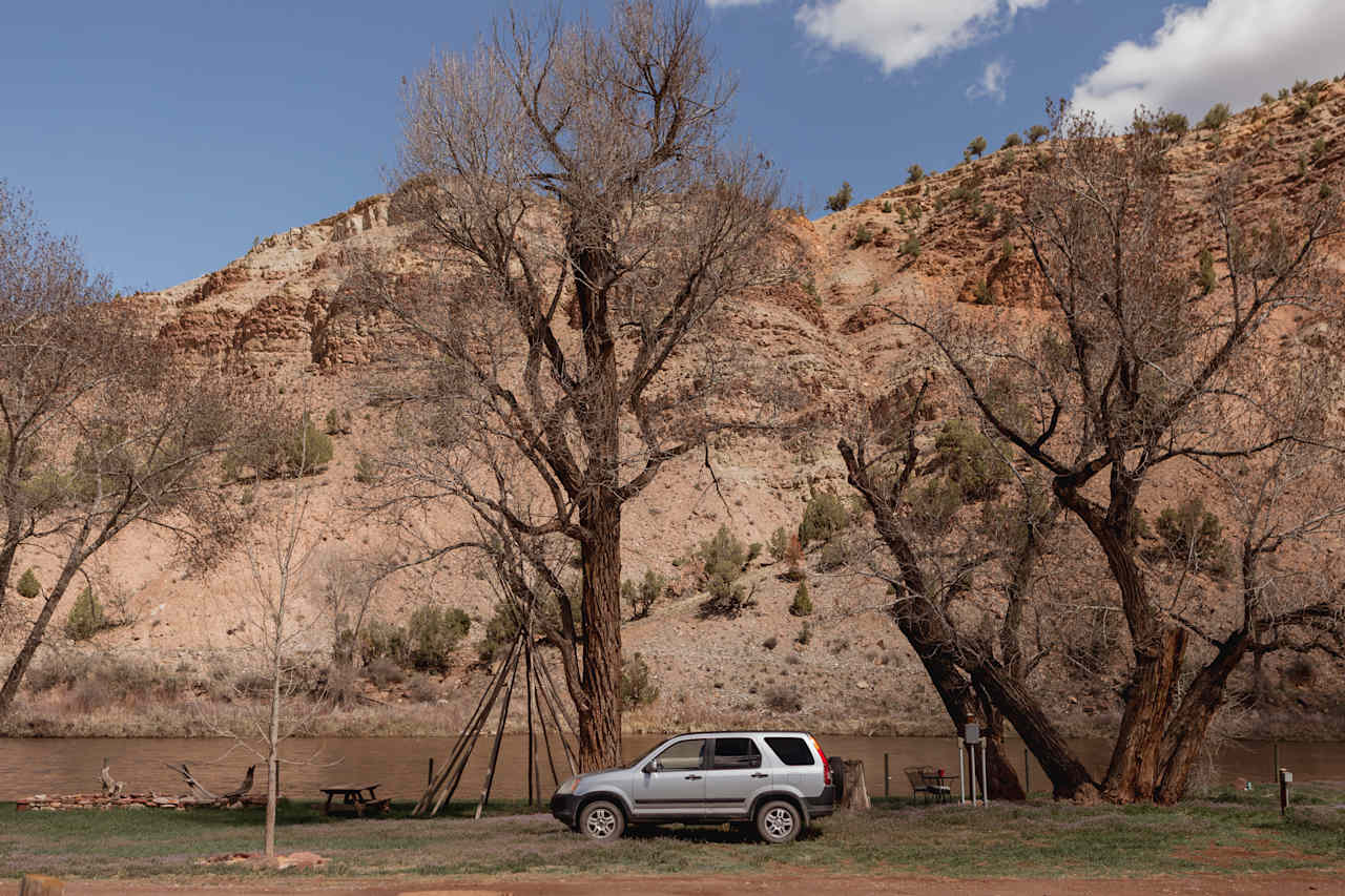 RV spots are right along the river with the huge colorful canyon backdrop rising behind them. 