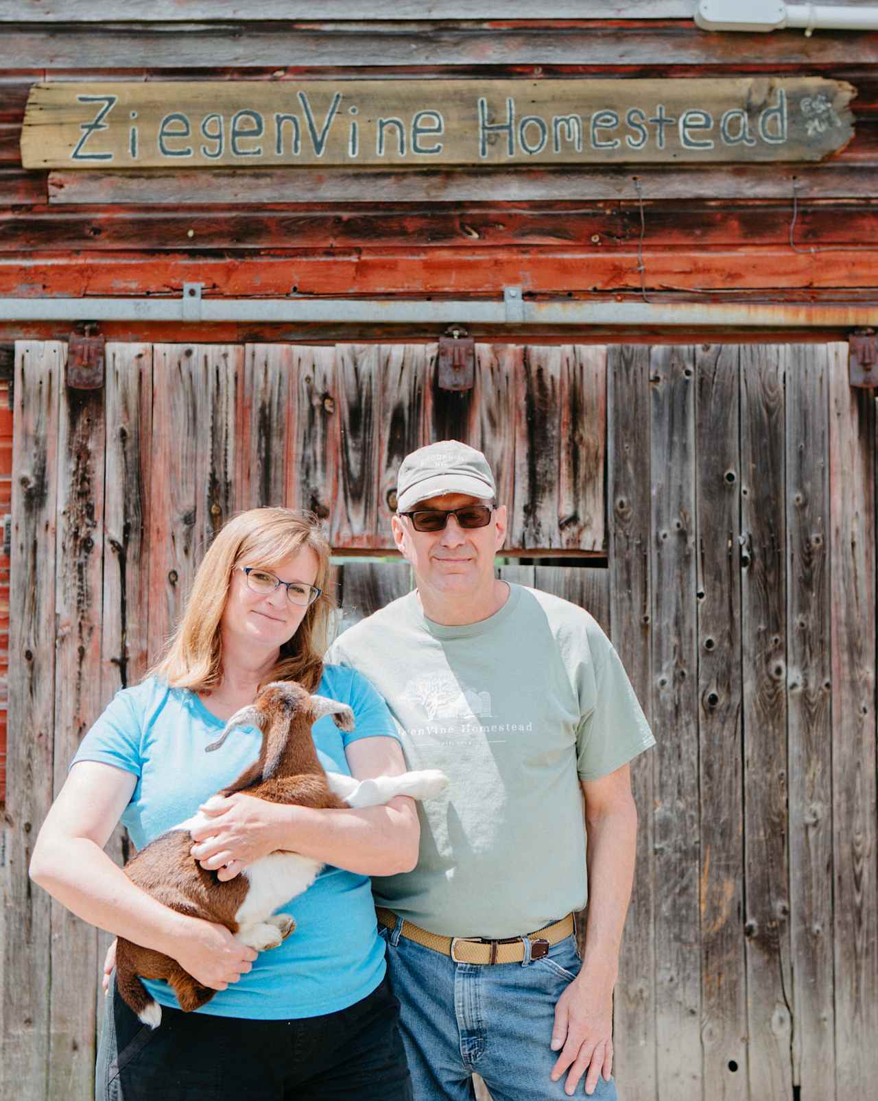 Landowners Randy and Allison, along with one of their young goats. 