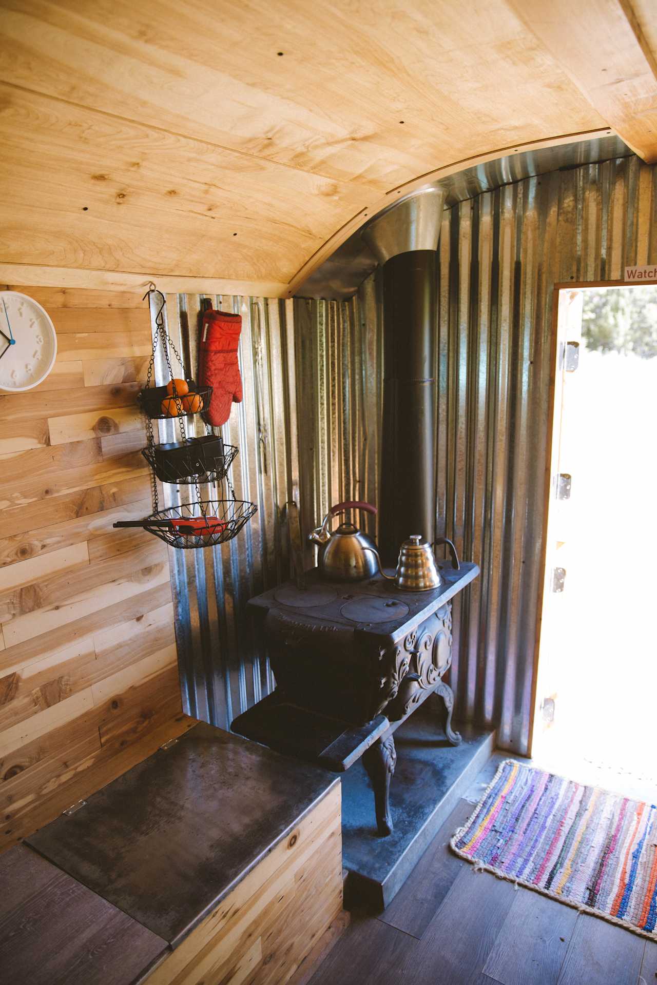 Tiny wood stove! There's firewood outside the cabin.