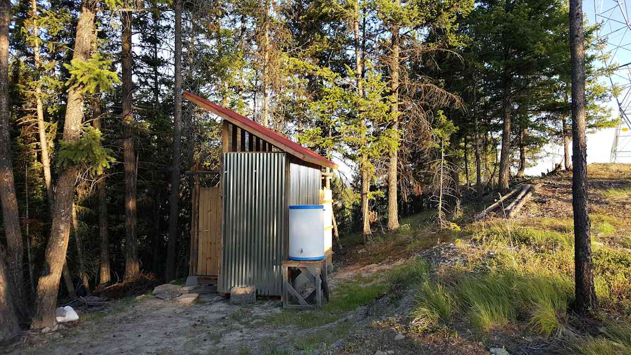 View of Out-building from campsite: Composting toilet, dry room, outdoor shower and water storage building.