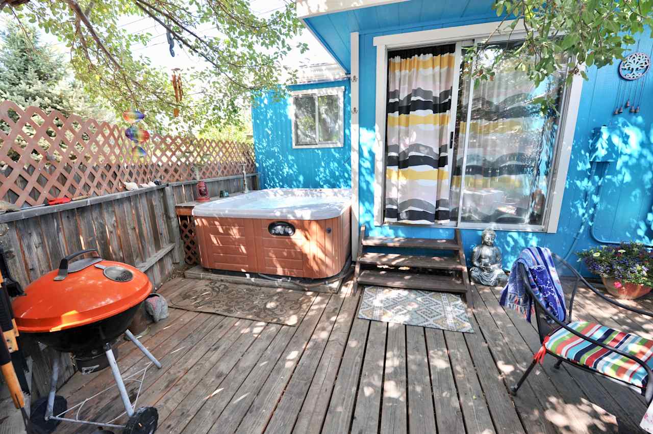 Your private patio with a hot tub, BBQ and seating area