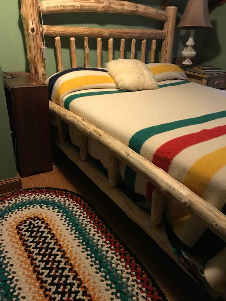 An Amish made cedar log queen size bed (with a very comfortable new latex mattress) Is on the second floor with plenty of views and soundscapes from the river.