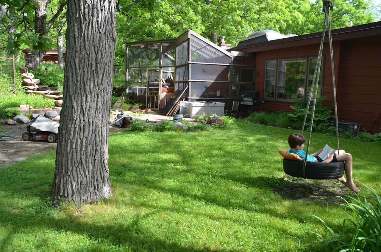 Backyard tire swing and screen porch.