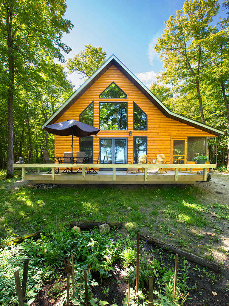 Wall of windows, deck and screened porch - cabin faces Strawberry Lake.