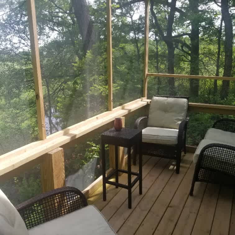 Screened in deck overlooking stream