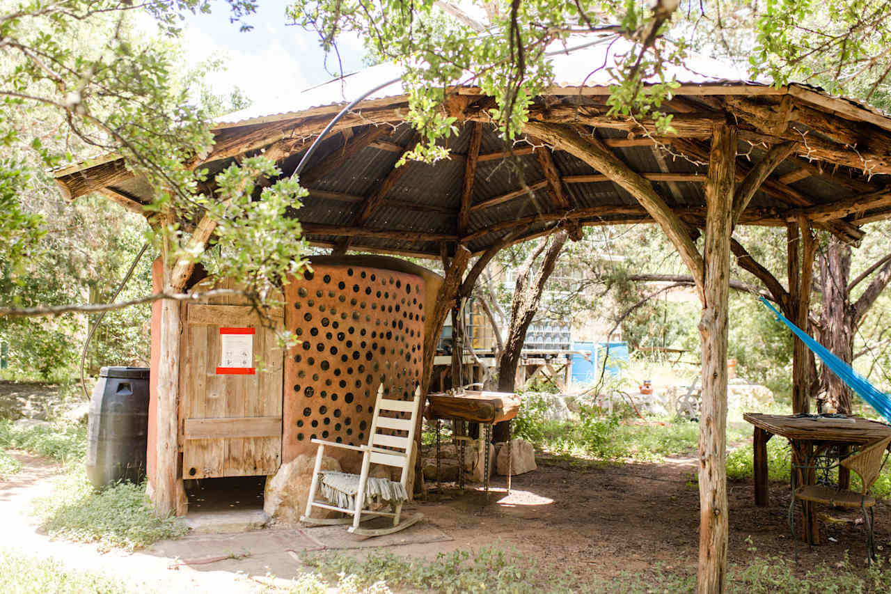 Pavilion with shower and seating in the shade.