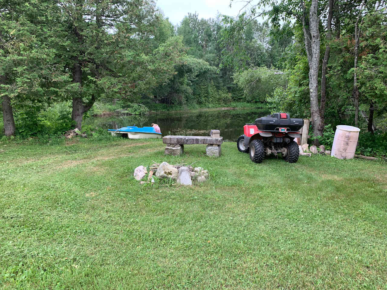 The camp site with fire pit and granite bench.  