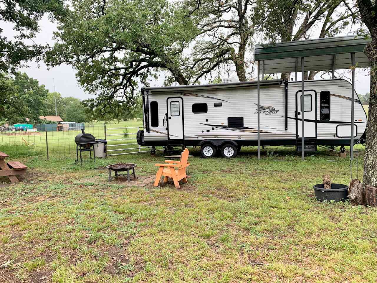 Enjoying our campsite. We have a slide out on our RV, so we couldn’t park completely under the cover. 