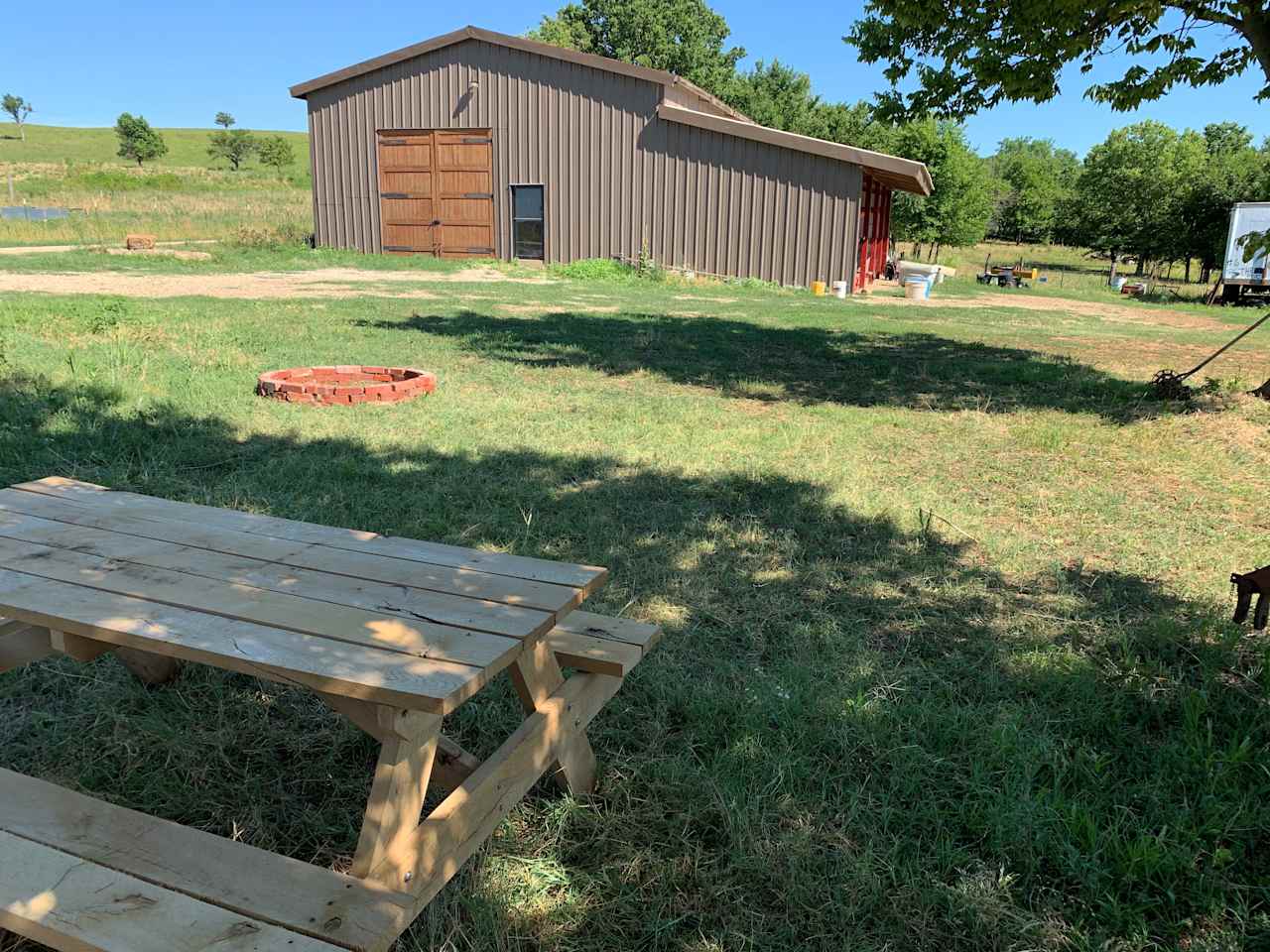 Here is the barnyard camp site including a picnic table, fire pit and shade for your tent or small camper