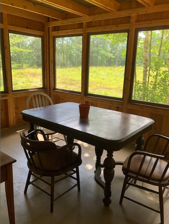 Roomy screened porch for dining, and hanging out. Rocking chair for time with your favorite author!