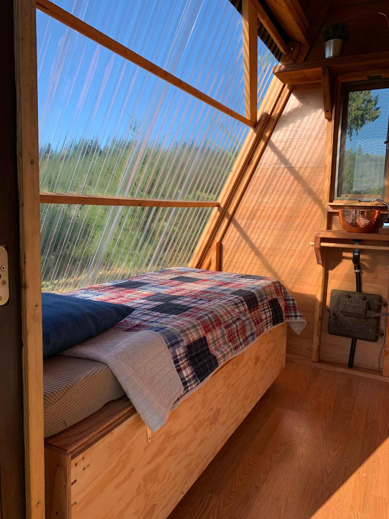 Twin bed (movable) with thick mattress waiting for your sleeping bag.  Note the see through wall can be raised to take advantage of the deck