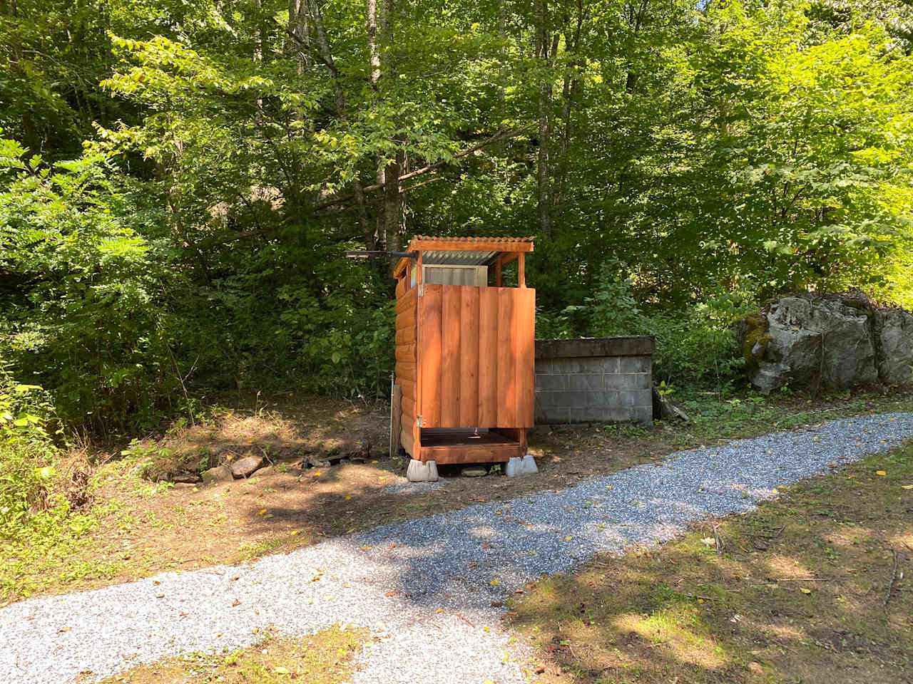 Simple shower with Thedford 365 toilet and outside spigot 